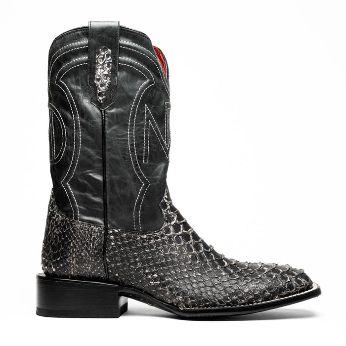 Marco Di Milano Missouri boots: Square toe, black leather upper with stitching, decorative pattern. Gray/white python skin lower, stacked heel. Structured, stylish cowboy design.
