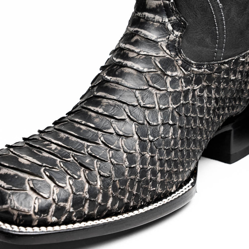 Marco Di Milano Missouri Stone cowboy boots. White python skin texture with black and white scales. Square toe design with subtle stitch detail. Black sole.
