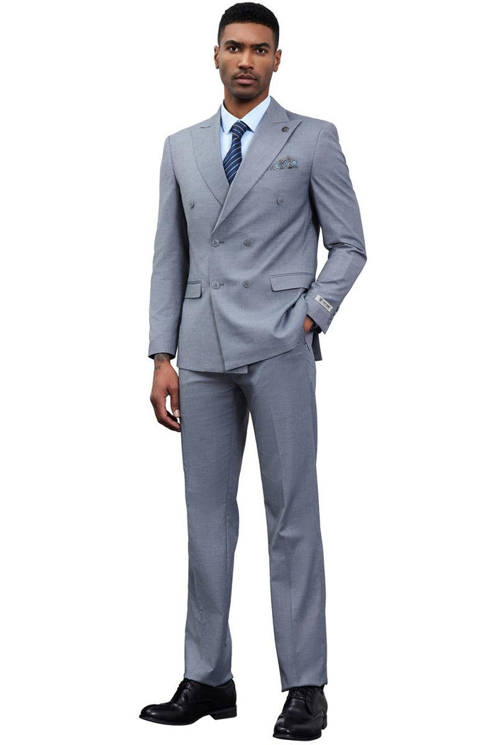 Stacy Adams men's grey double-breasted suit. Tailored silhouette, structured jacket, straight-leg trousers. Lightweight fabric, solid grey. Features button closure, lapels, and pocket square. Paired with a light blue shirt, striped tie, and black dress shoes.
