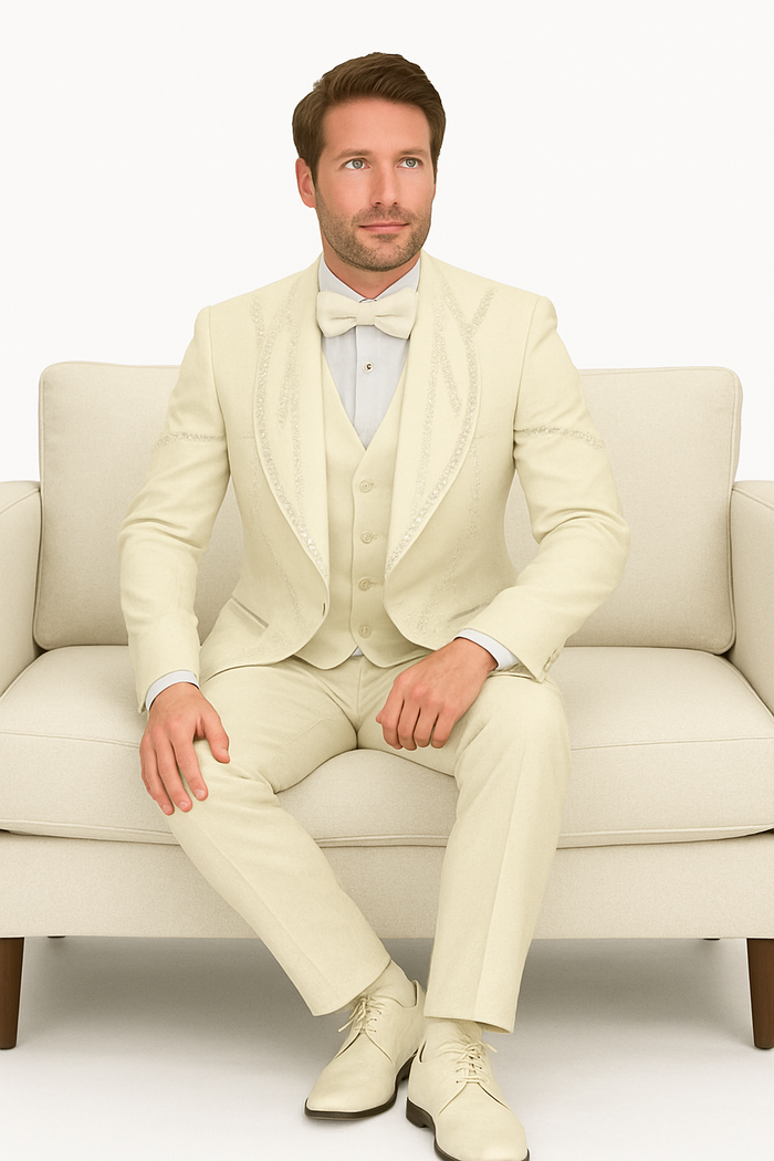 Off-white Italian wool tuxedo. Modern fit, three-piece: jacket with shawl collar, matching trousers, and waistcoat. Smooth fabric with a subtle sheen.
