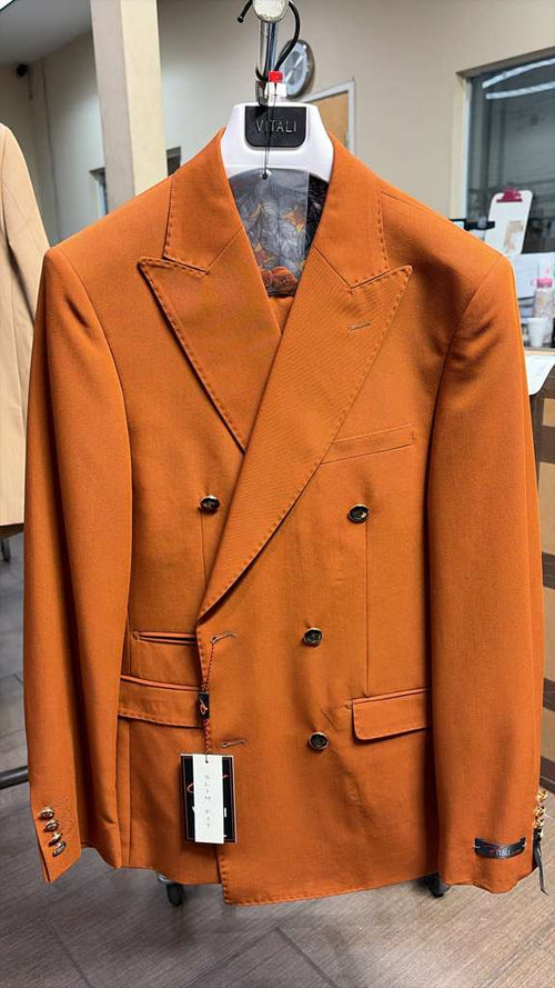 The Vitali brand men's double-breasted suit is made of a smooth burnt orange fabric. It features a notched lapel, double rows of black buttons, and two front pockets.