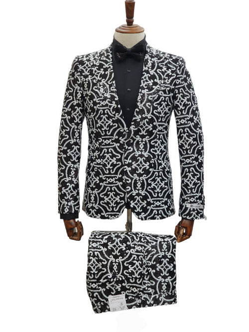 Black sequin tuxedo for men with structured silhouette, single-breasted design, and peaked lapels. Intricate silver sequin patterns. Includes matching bow tie and fabric. Tailored suit base.
