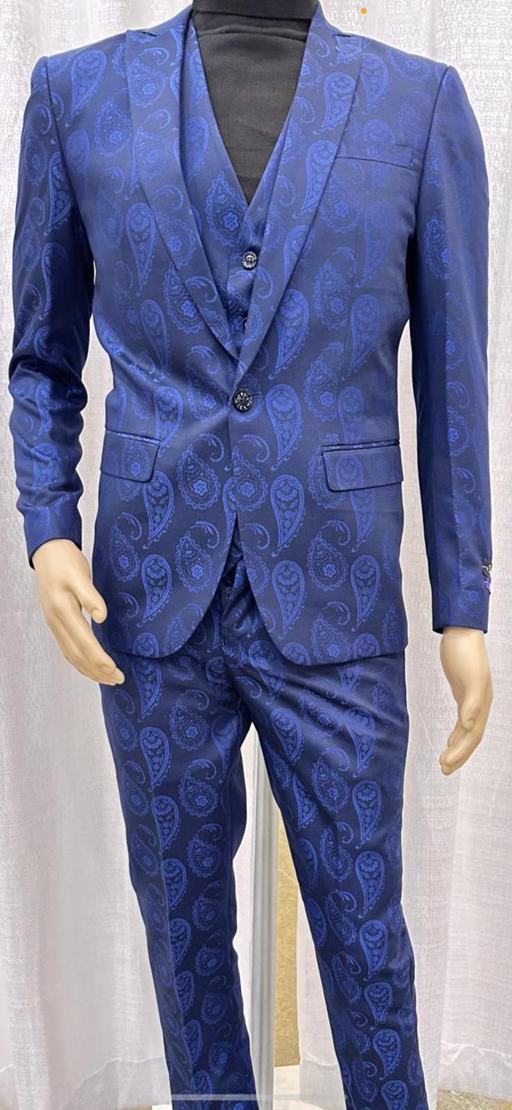 Men's sapphire blue paisley 3-piece suit. Includes a fitted 2-button blazer, vest, and tailored trousers. Features a repeating paisley pattern in blue shades.