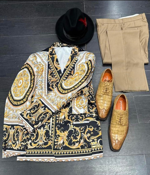 Black and gold baroque blazer with matching tan pants. A black hat with a red feather and brown crocodile-patterned shoes complete the stylish ensemble.
