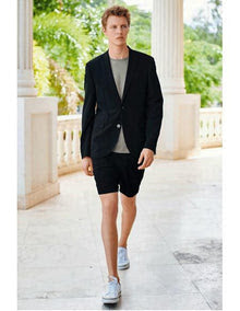 Men's black summer business suit featuring a tailored blazer with a single button closure and matching black shorts, made from lightweight fabric. The blazer has a sleek design, complemented by a round-neck gray shirt underneath.
