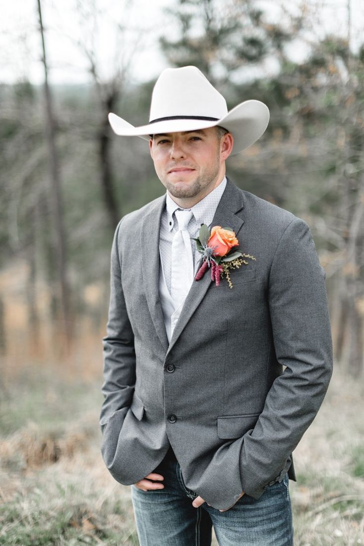 Gray men's western blazer. Tailored fit, structured shoulders, long sleeves, button closure, and two front pockets. Smooth, woven gray fabric.
