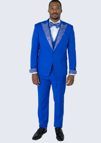 Royal blue tuxedo suit with white lapel & cuff embellishments. Includes a two-button jacket, white shirt, and bow tie. Features straight-leg trousers.
