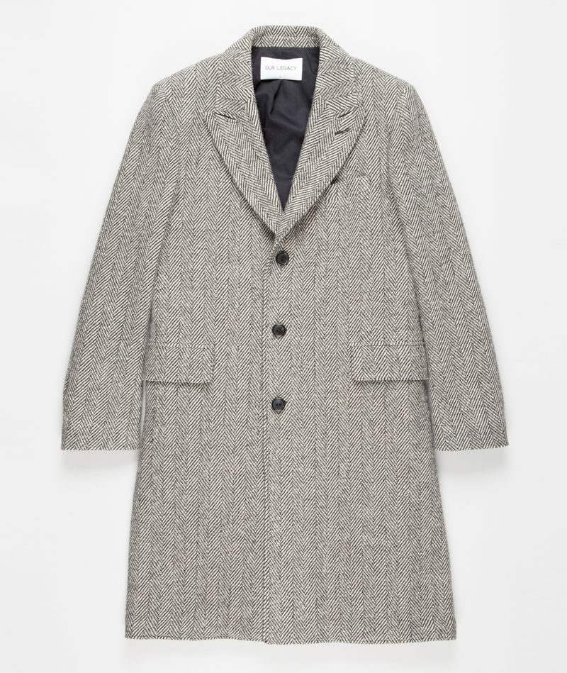 Men's grey herringbone long overcoat. Structured silhouette, notched lapel, button closure, and long sleeves. Features a grey herringbone pattern, two front pockets, and a black interior lining.
