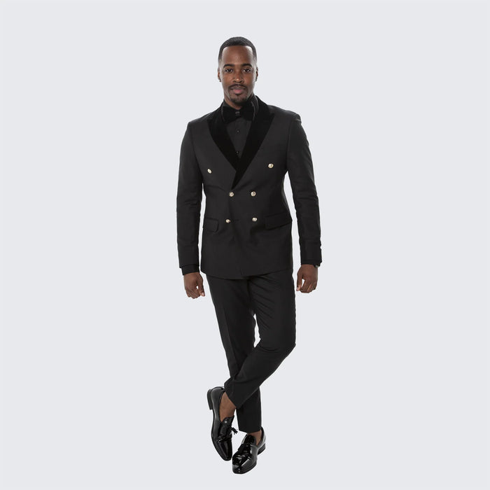 Black double-breasted tuxedo suit for men. Structured blazer with shawl collar & gold buttons. Slim-fit trousers. Solid black, sleek finish. Classic formal wear.
