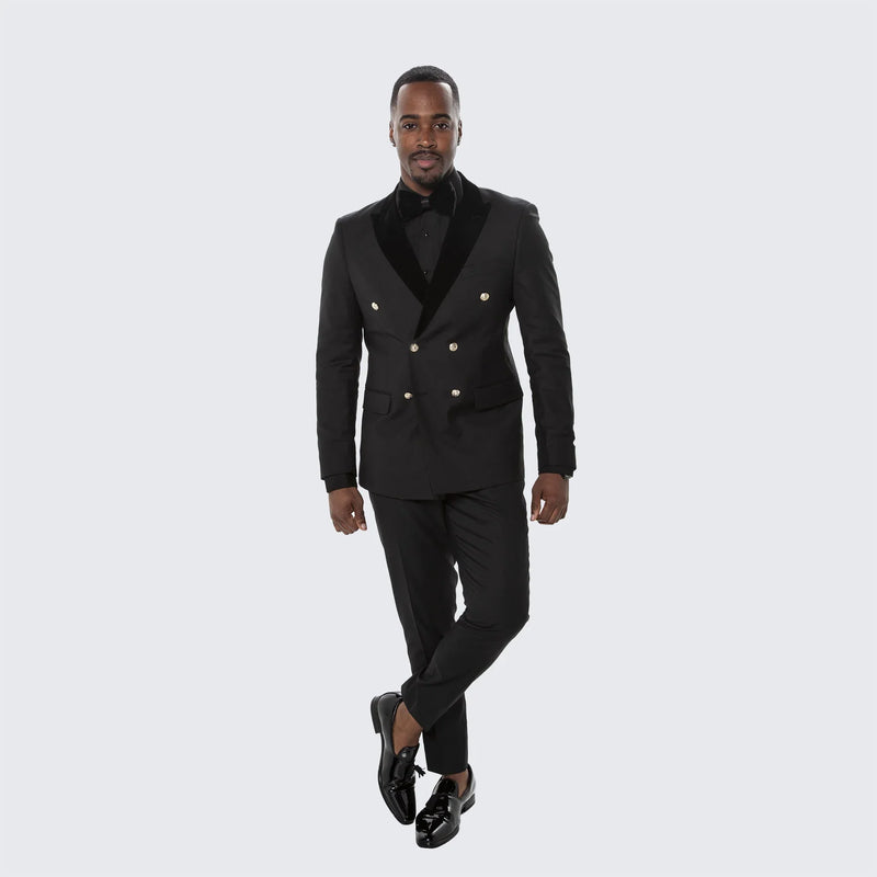 Black double-breasted tuxedo suit for men. Structured blazer with shawl collar & gold buttons. Slim-fit trousers. Solid black, sleek finish. Classic formal wear.
