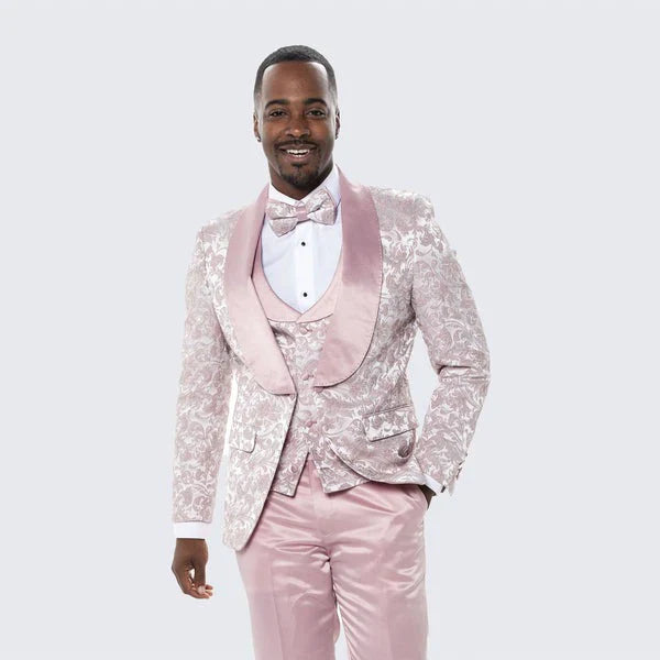 Men's light pink dusty rose floral tuxedo suit. Textured floral pattern, satin shawl collar, bow tie. Three-piece design: jacket, vest, trousers.
