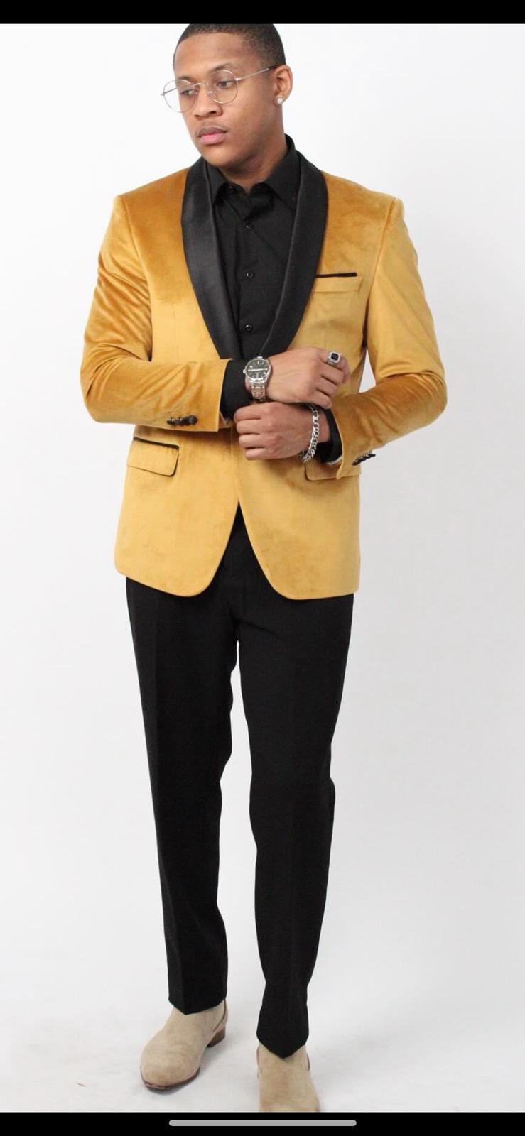 Alberto Nardoni men's mustard gold velvet tuxedo jacket. Fitted silhouette, black shawl collar, single-button closure, and two front pockets. Smooth velvet texture.
