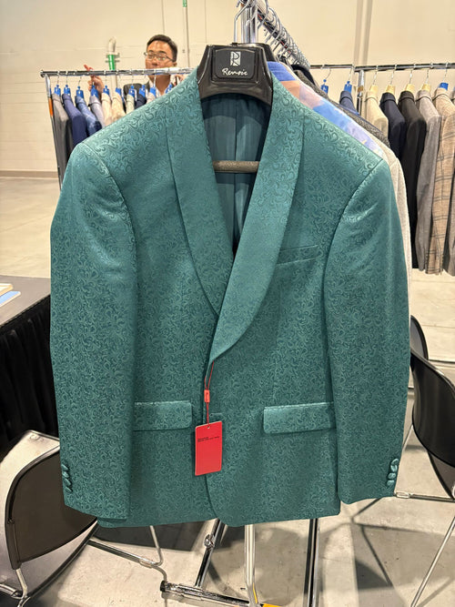 Men's teal green floral jacquard blazer. Slim fit tuxedo jacket with structured silhouette, wide lapels, textured floral pattern, and two front pockets.
