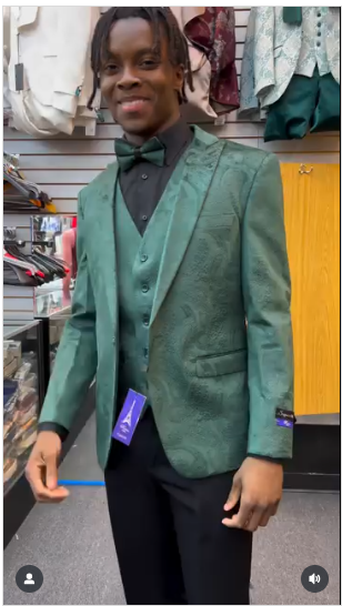 Men's emerald green paisley tuxedo: slim-fit three-piece suit. Blazer, vest, pants. Formal wear with visible paisley pattern and button details.
