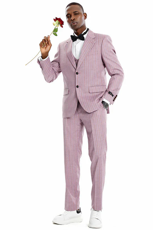 Men's dusty rose pink pinstripe three-piece suit. Single-breasted jacket, notched lapels, matching vest, and slim-fit trousers. Subtle darker pinstripes. Includes white shirt, bow tie.
