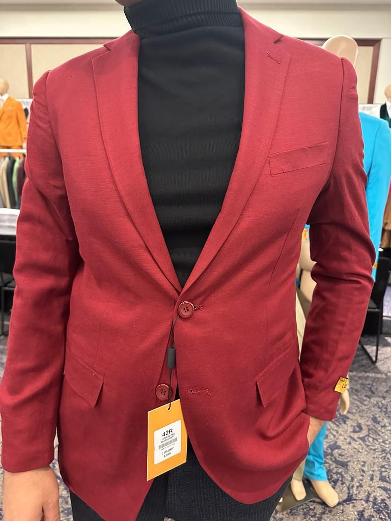 Alberto Nardoni men's burgundy sport coat. Slim fit, two-button, notched lapel, flap pockets, chest pocket, and button cuffs. Smooth, slightly shiny fabric. Solid burgundy color. Tailored shape.
