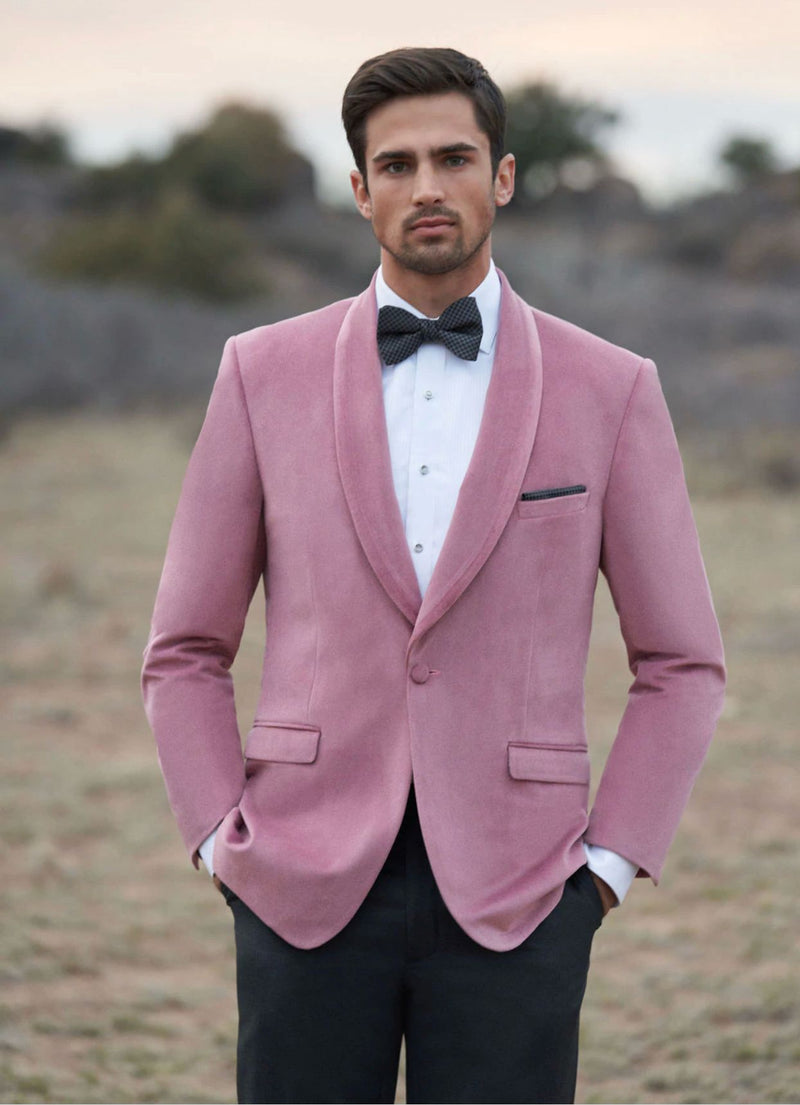Men's pink velvet tuxedo jacket. Shawl lapel, slim fit, and single-button closure. Features soft, textured fabric with two front pockets. A stylish dinner jacket.

