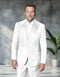 Modern fit three-piece tuxedo in white, featuring floral appliqué on the left side of the jacket. The tuxedo includes a satin shawl lapel and a three-button closure. A matching vest is worn underneath the jacket, complemented by a bow tie.