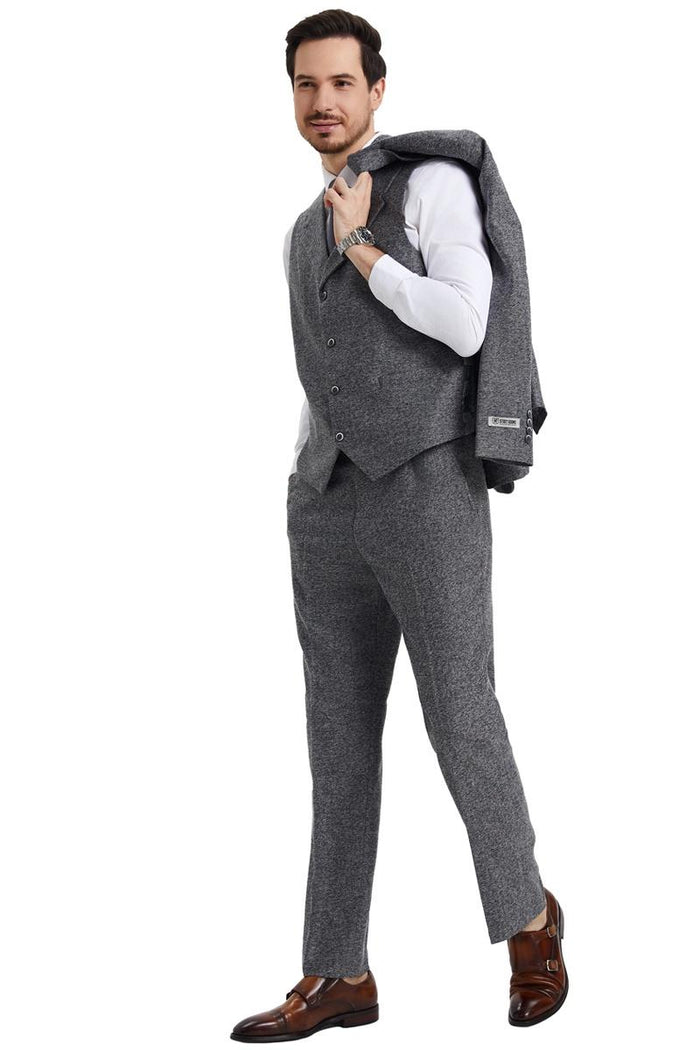 Men's Stacy Adams vintage grey herringbone tweed suit. Includes fitted vest and trousers with a textured, subtle herringbone pattern. Features a grey colorway; vest layered over a white shirt.
