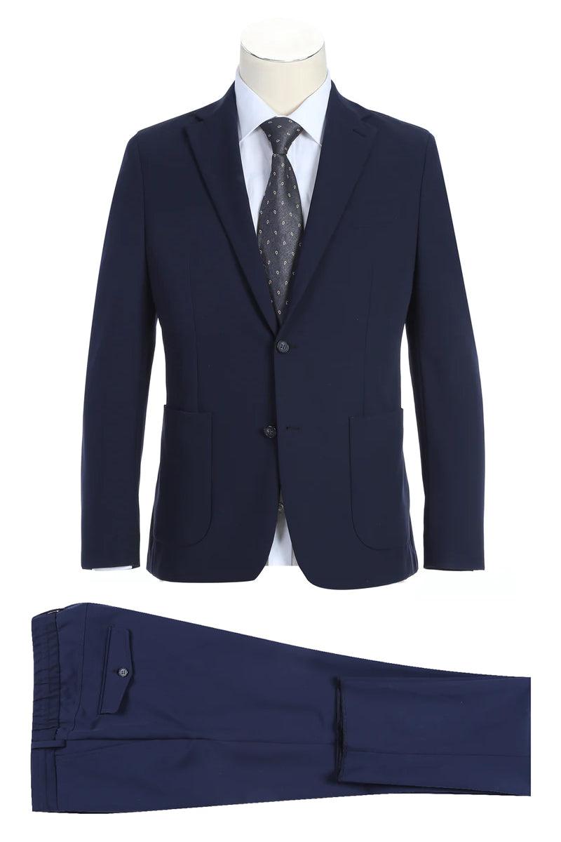Pelagos Navy Travel Suit: Unconstructed blazer with a slim fit, notched lapels, and two-button closure. Matching trousers with a single back pocket. Solid navy, smooth texture.
