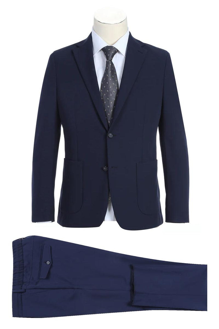 Pelagos Navy Travel Suit: Unconstructed blazer with a slim fit, notched lapels, and two-button closure. Matching trousers with a single back pocket. Solid navy, smooth texture.
