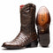 Marco Di Milano Phoenix cowboy boots in aged brown caiman crocodile. Round toe, pointed shaft, and leather sole with engraved branding. Features textured dark brown finish and red lining.
