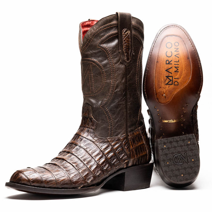 Marco Di Milano Phoenix cowboy boots in aged brown caiman crocodile. Round toe, pointed shaft, and leather sole with engraved branding. Features textured dark brown finish and red lining.
