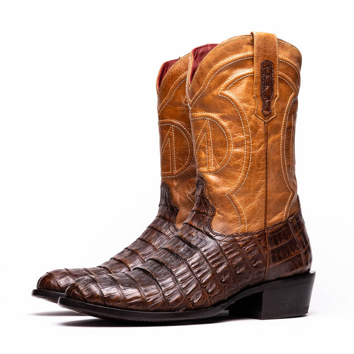 Two-tone Marco Di Milano cowboy boots. Light brown smooth leather upper, dark brown caiman crocodile lower. Pointed toe, slightly raised heel, subtle stitching. Red fabric lined.
