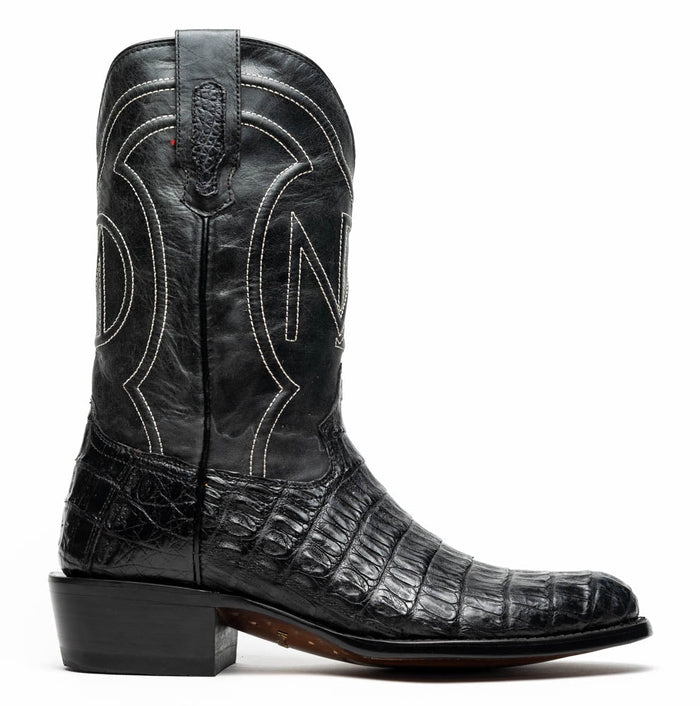 Marco Di Milano Phoenix cowboy boots. Black caiman crocodile leather, round toe. Intricate white stitching on shaft with decorative pattern. Block heel for stability.
