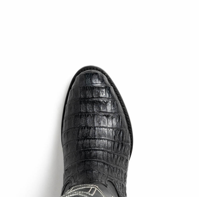 Black caiman crocodile cowboy boots by Marco Di Milano. Round toe, textured surface. Black caiman leather upper with reptilian scales and decorative stitching for enhanced structure.
