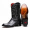 Marco Di Milano Phoenix cowboy boots in glossy black caiman crocodile. Round toe, tall shaft, and intricate stitching. Red lined interior. Stacked heel. Branded sole.
