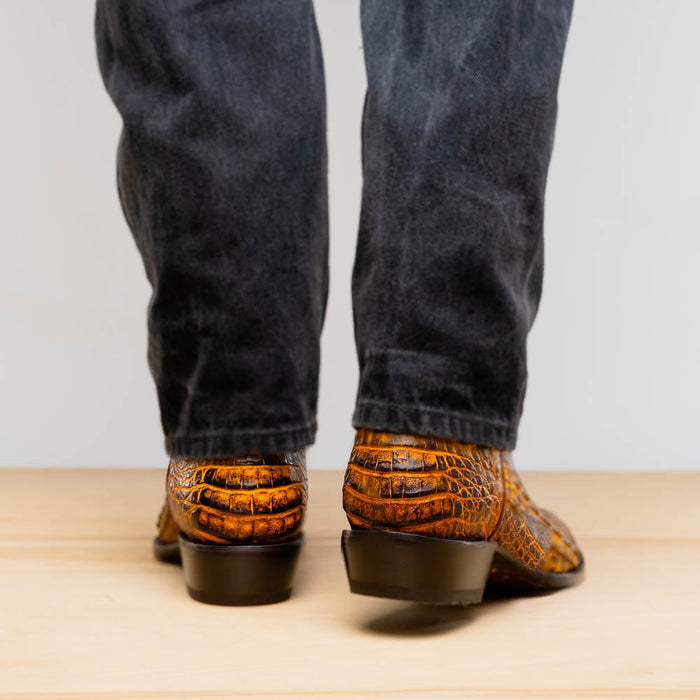 Mustard brown Marco Di Milano Phoenix cowboy boots. Caiman crocodile leather with textured pattern, round toe, and medium heel. Fitted back design.
