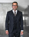 The Statement mens 3 piece fashion suit features a unique checker pattern with a deep navy coloration. The jacket has a tailored fit and is structured with defined lapels. The vest beneath complements the jacket and is also in navy, continuing the checker motif.