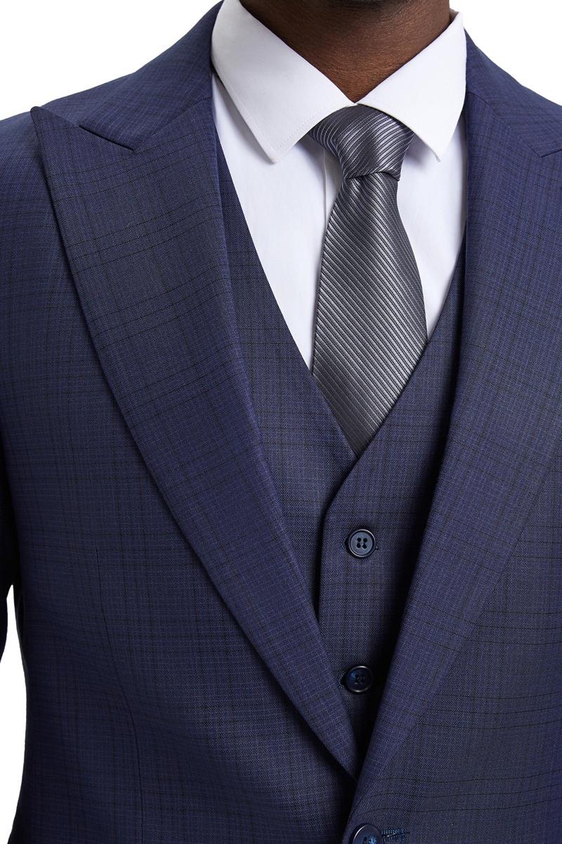 Men's Stacy Adams eggplant purple suit. One-button, vested, wide peak lapel, windowpane plaid. Structured shoulders, tailored fit. Smooth, textured fabric. Matching vest included.
