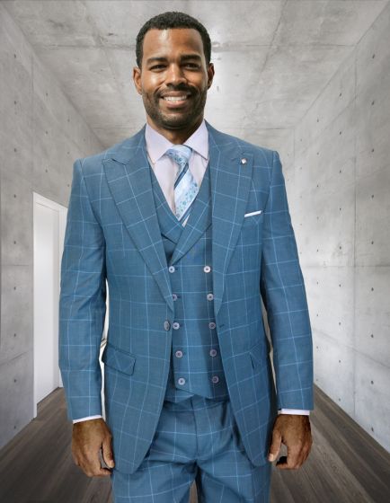 The Statement mens 3 piece wide leg suit features a light blue color with a checked pattern. The suit consists of a jacket, vest, and trousers, all constructed from a smooth fabric. The jacket has a structured form with a single button closure, while the trousers exhibit a wide-leg design.