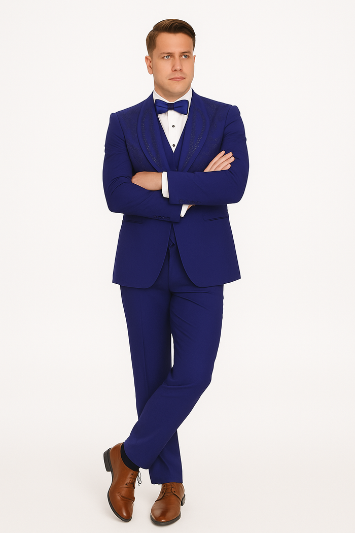 Royal blue Italian wool tuxedo: modern fit, three-piece. Tailored jacket with peaked lapels, matching trousers, and formal white shirt with bow tie.
