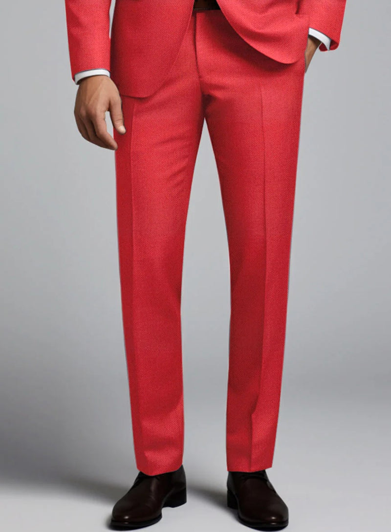 Tailored red suit with matching trousers. Straight cut, textured fabric. Slim-fit trousers with smooth finish. Black tie. Vibrant red color for a striking look.
