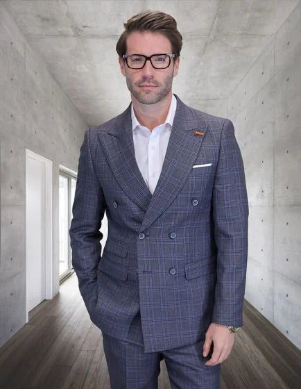 The Statement men's outlet two-piece suit is made of 100% wool, featuring a double-breasted design. The fabric has a gray base with a subtle plaid pattern in lighter and darker shades. The suit includes a white dress shirt underneath, visible at the collar.
