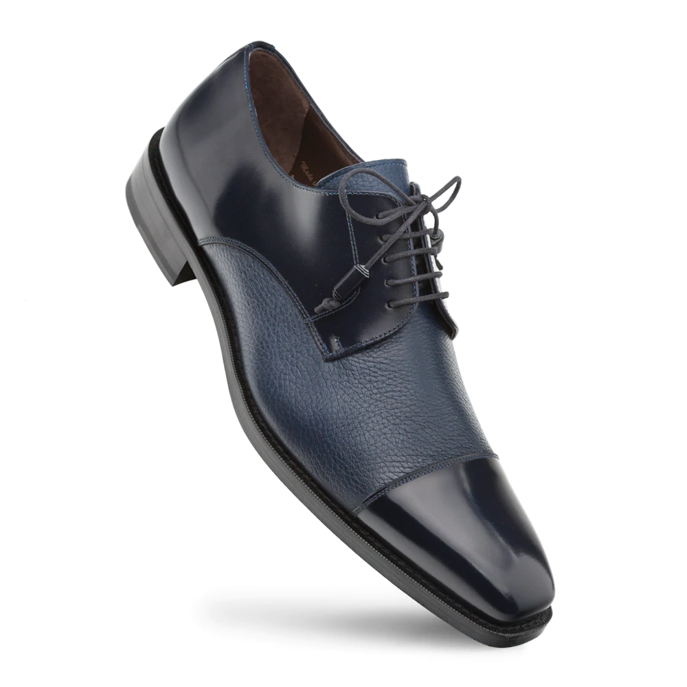 Mezlan Soka cap-toe shoes in blue calfskin & deerskin. Glossy cap, textured grain, rounded toe, lace-up. Black outsole. A stylish blend of textures and color.
