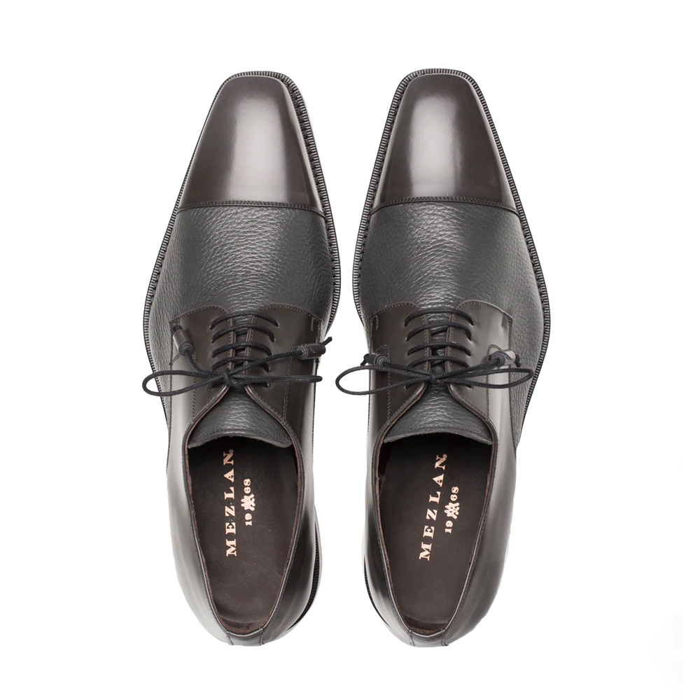 Mezlan Soka gray cap-toe shoes. Calfskin & deerskin upper, rounded toe with a slight square. Black laces, flat sole. Glossy toe cap contrasting textured body.
