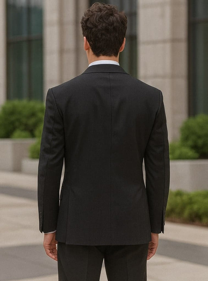 Black Steve Harvey men's double-breasted suit. Modern fit, structured shoulders, tailored silhouette, smooth fabric (wool or blend) with subtle sheen. Minimalist back, notched collar, buttoned cuffs, two vents.
