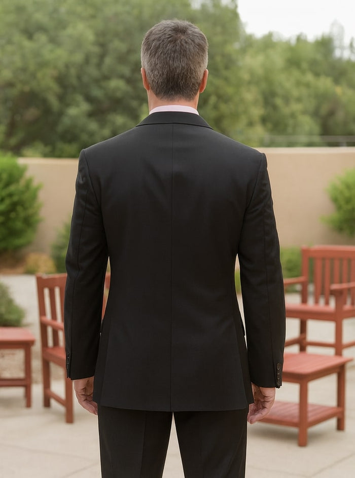 Men's Steve Harvey suit: Double-breasted, modern fit, all black. Tailored silhouette with structured shoulders, straight hem. Smooth fabric (blend likely). Button cuffs, center back seam.

