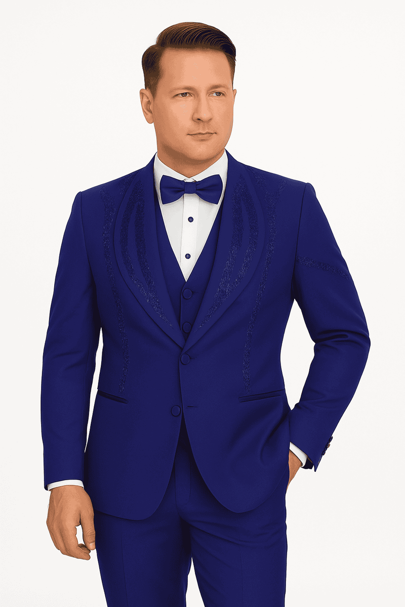 Royal blue Italian wool tuxedo: modern fit, single-breasted jacket, notched lapels, embroidered detail. Includes vest, trousers. Paired with white dress shirt and matching bow tie.
