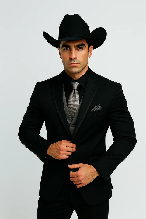 Men's black western tuxedo: fitted silhouette, smooth fabric. Silver vest & tie. Cowboy hat included. Classic western formal wear.
