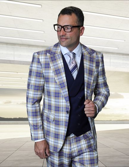 The Statement men's 3-piece plaid suit features a modern fit with a structured blazer, a waistcoat, and slim-fit trousers. The primary material is 100% wool, characterized by a multicolored plaid pattern in shades of blue, yellow, and white. The blazer has peaked lapels and front pockets.