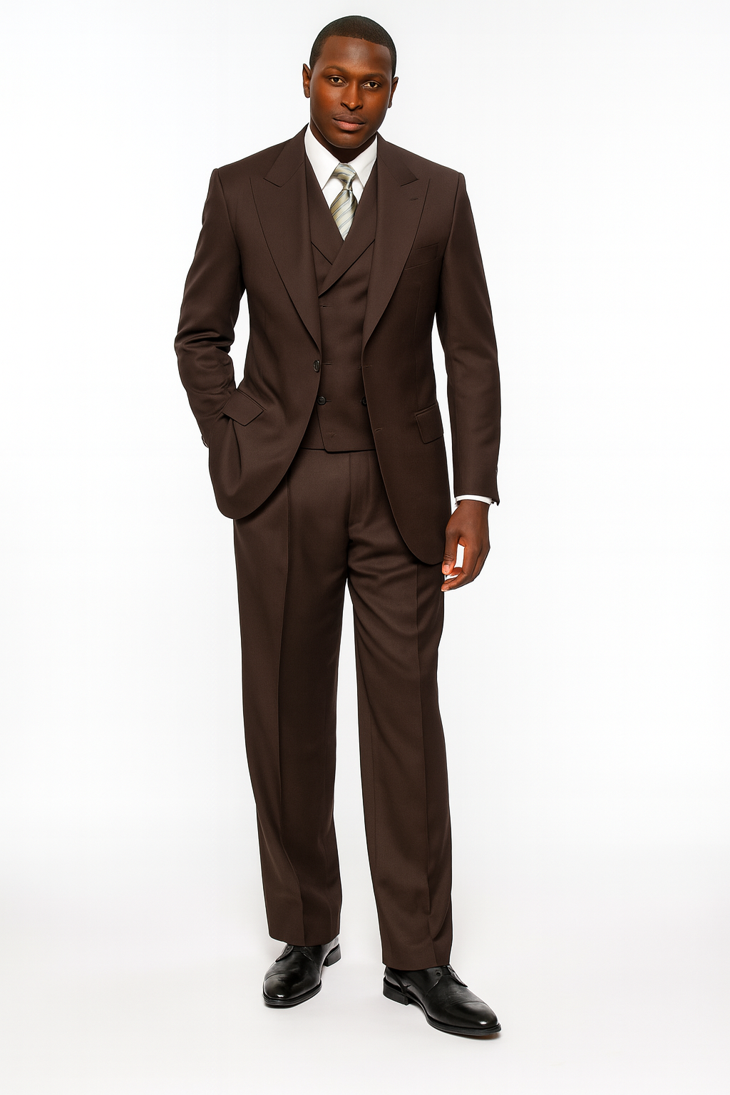 Chocolate brown, three-piece suit in 100% wool super 150s. Features a double-breasted vest and pleated pants. Tailored, structured fit with smooth, clean lines.
