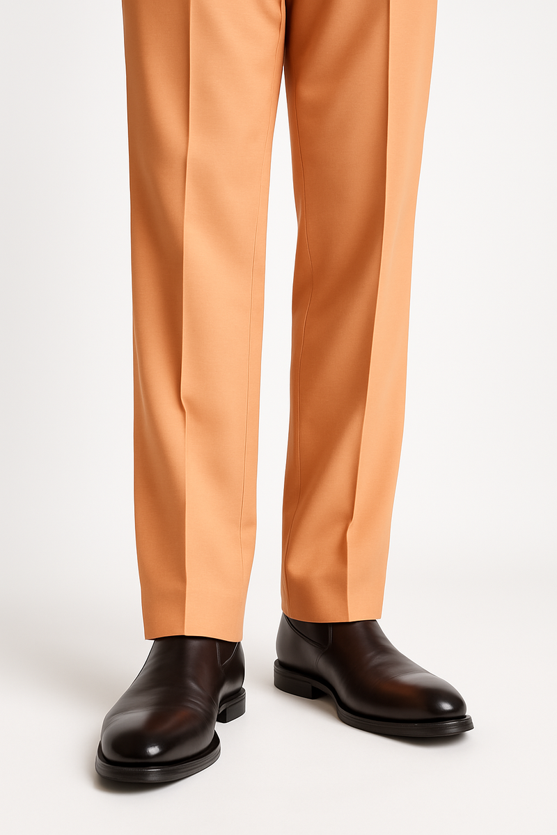Tiglio Luxe Creamsicle wool dress pants with semi-wide leg in light orange. Smooth texture, tailored fit with clean lines. Straight from waistband, extending to black leather shoes.
