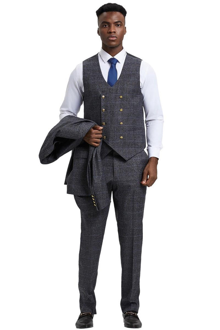 Charcoal grey suit by Stacy Adams. Double-breasted vest with windowpane plaid. Matching trousers & peak lapel jacket. Textured fabric, formal look.
