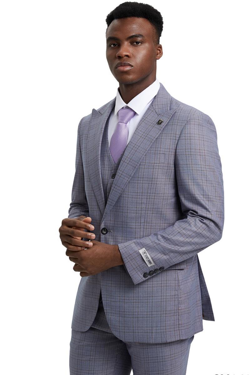 Light grey men's Stacy Adams suit with windowpane plaid. Features a fitted, one-button jacket with wide peak lapels, matching vest, and tailored trousers. Smooth, polished fabric. Visible stitching details.
